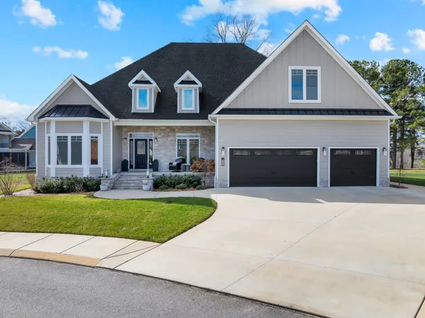 a front view of a house with a yard and garage