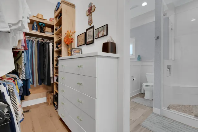 a living room with furniture a flat screen tv and kitchen view