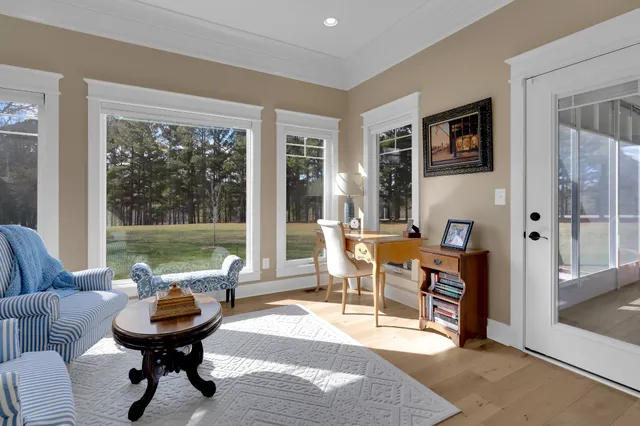 a living room with furniture kitchen view and a flat screen tv