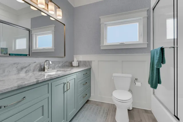 a bathroom with a shower and a sink