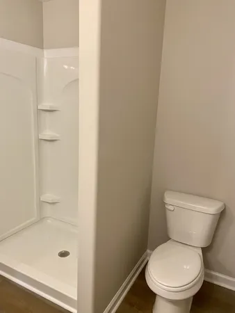 a white toilet sitting next to a bathroom sink