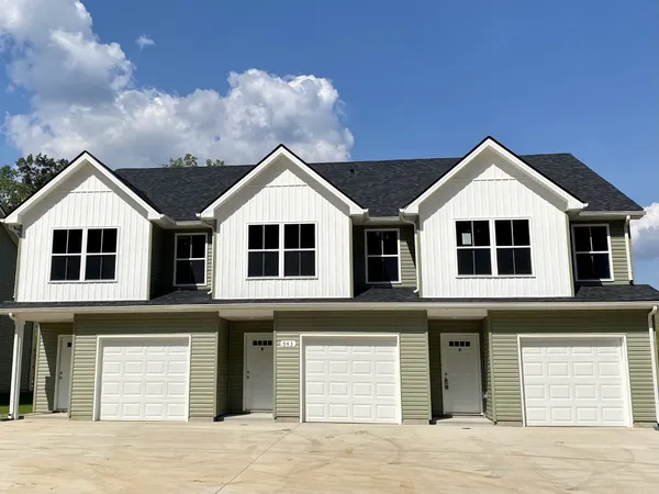 a front view of a house with a yard