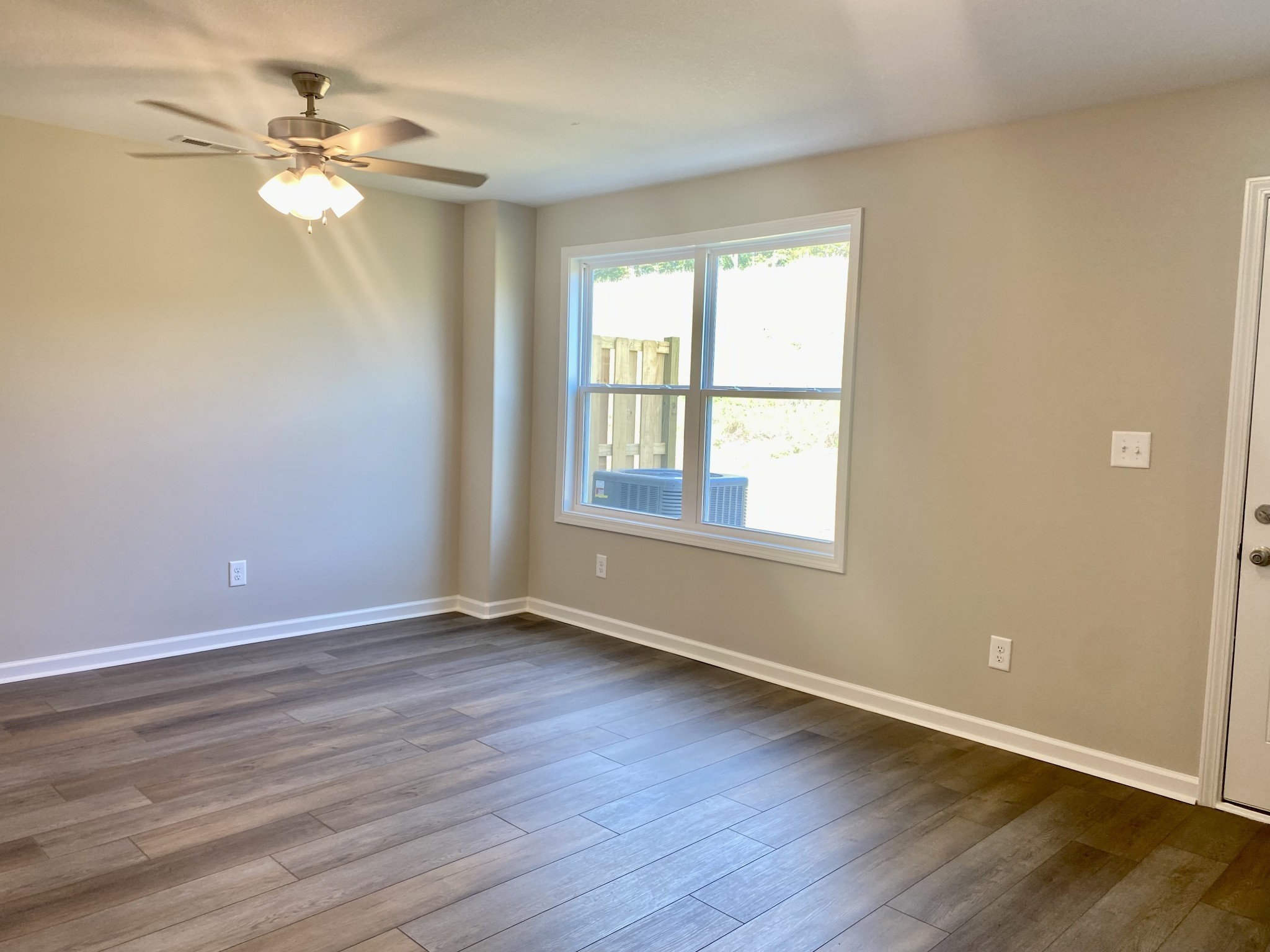 943 Center Road, Unit A Clarksville, TN 37042 - Photo 4 of 23 a view of an empty room with wooden floor and a window