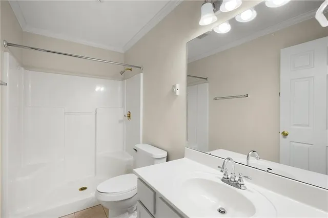 a bathroom with a sink toilet mirror and shower