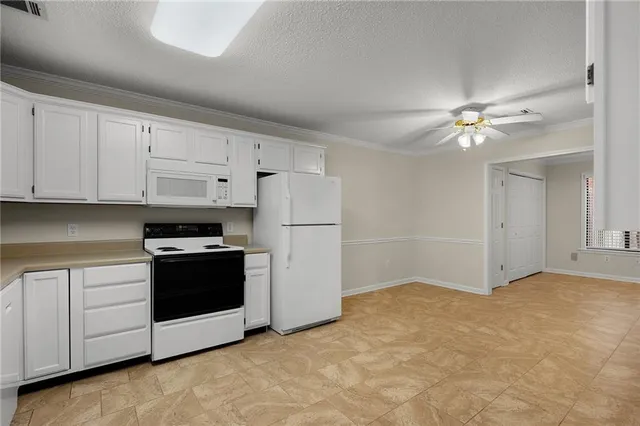 a kitchen with cabinets and stainless steel appliances