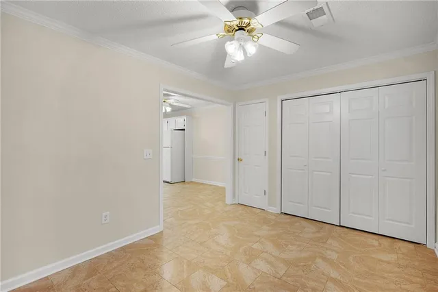 a view of a livingroom with a ceiling fan and window