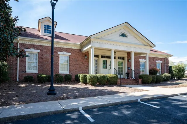 a view of a patio with chairs and umbrellas on a patio