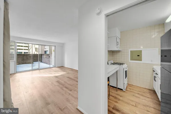 a room with a stove a sink and a refrigerator