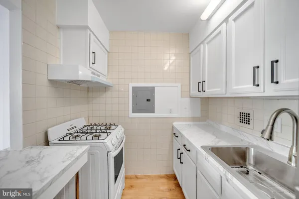 a kitchen with stainless steel appliances granite countertop a sink stove and cabinets