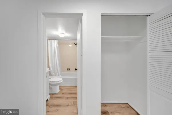 a bathroom with a granite countertop toilet and a sink