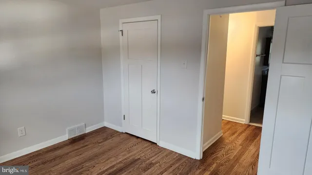 a view of a room with wooden floor