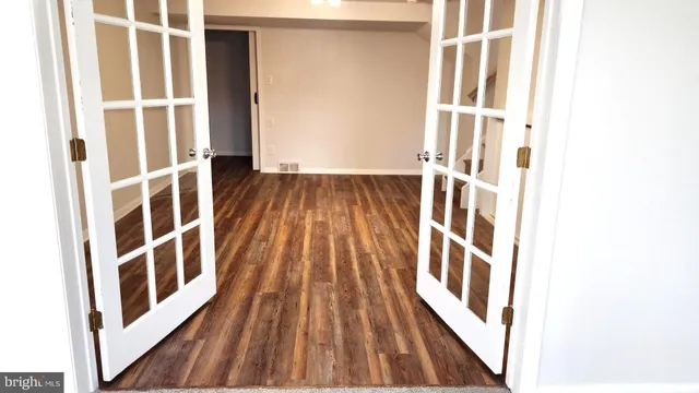 a view of an empty room and wooden floor