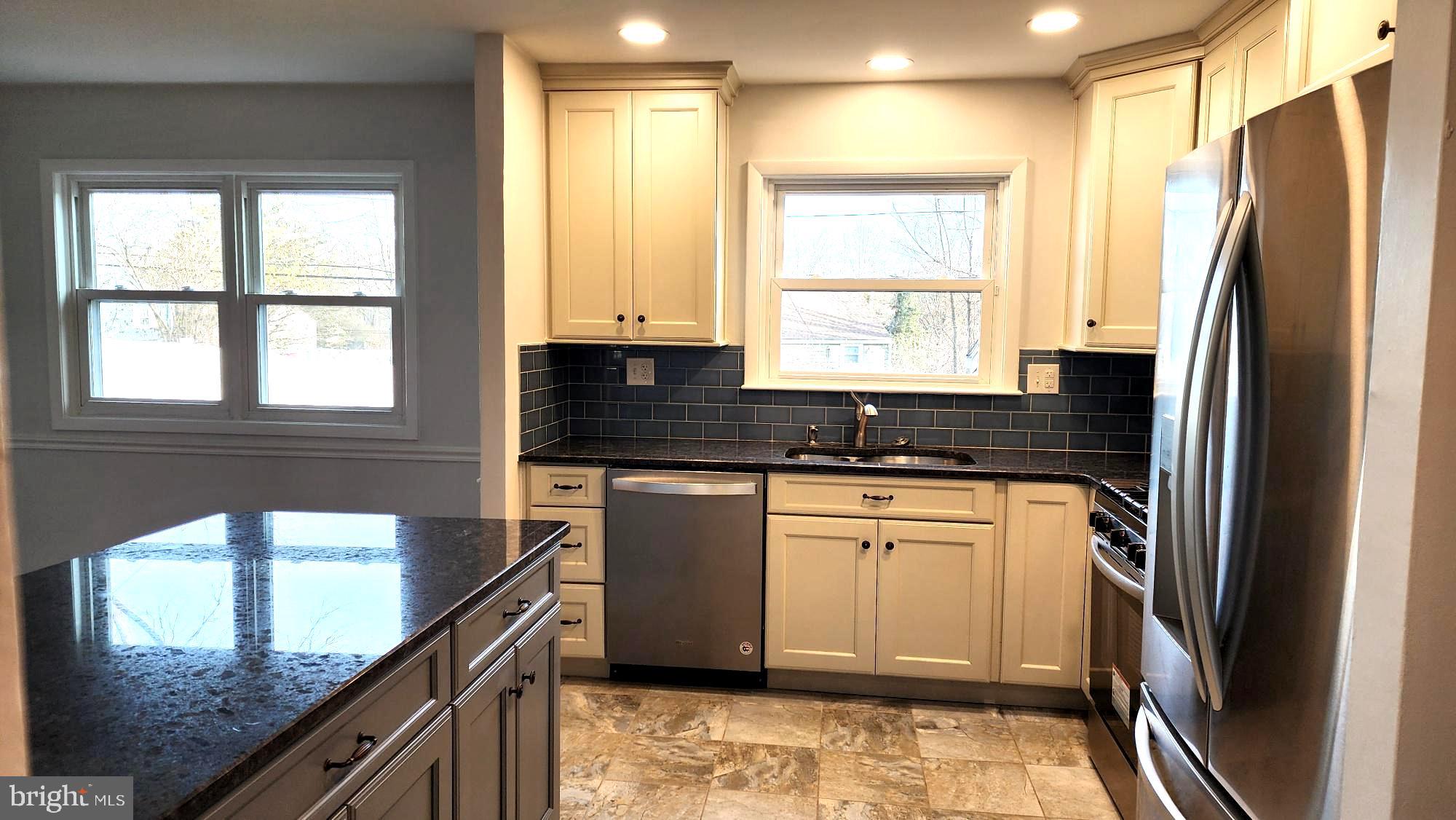 213 Upper Valley Road North Wales, PA 19454 - Photo 8 of 28 a kitchen with stainless steel appliances granite countertop a refrigerator a sink and white cabinets