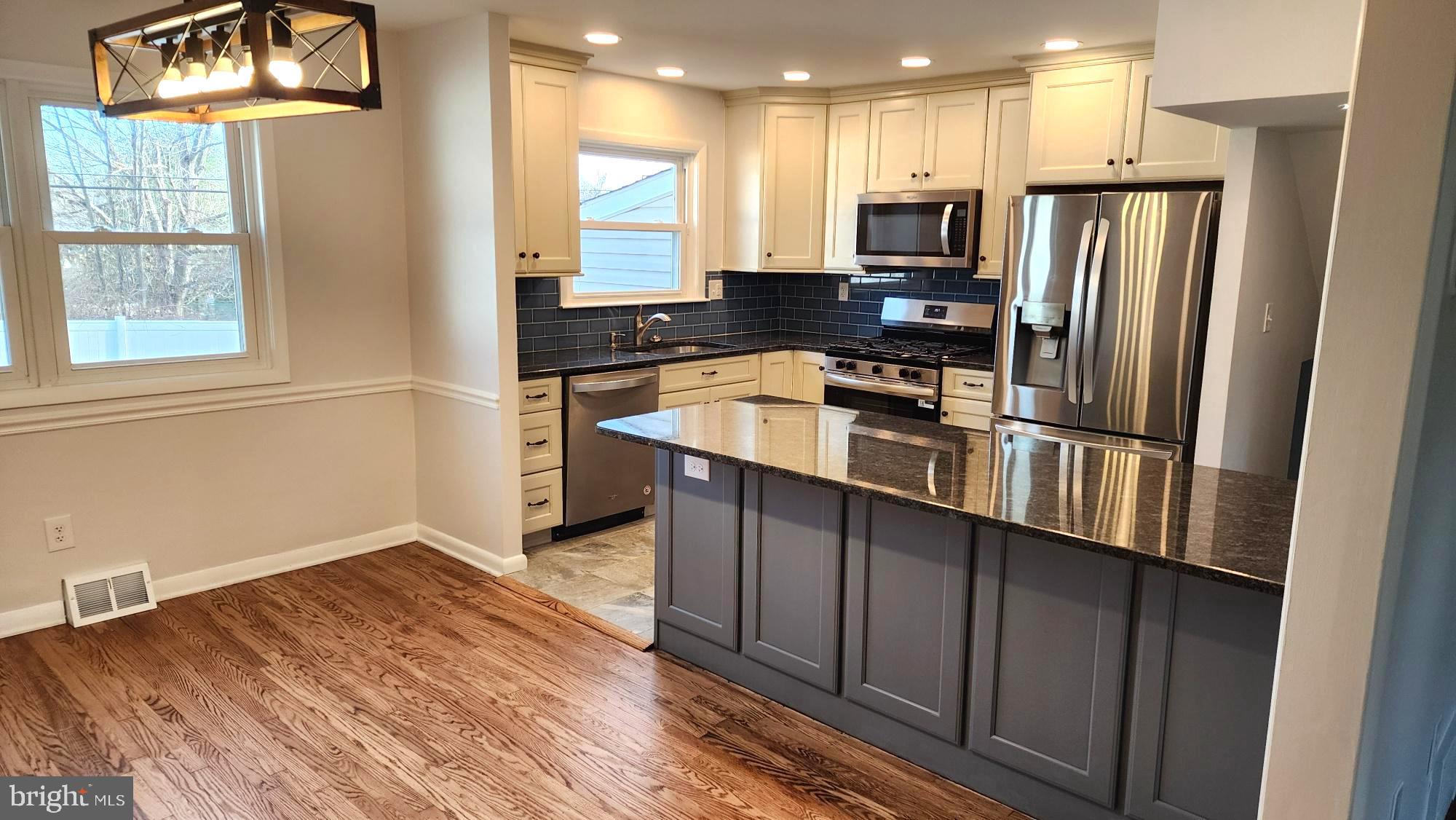 213 Upper Valley Road North Wales, PA 19454 - Photo 9 of 28 a kitchen with stainless steel appliances granite countertop a refrigerator a stove a sink and a microwave