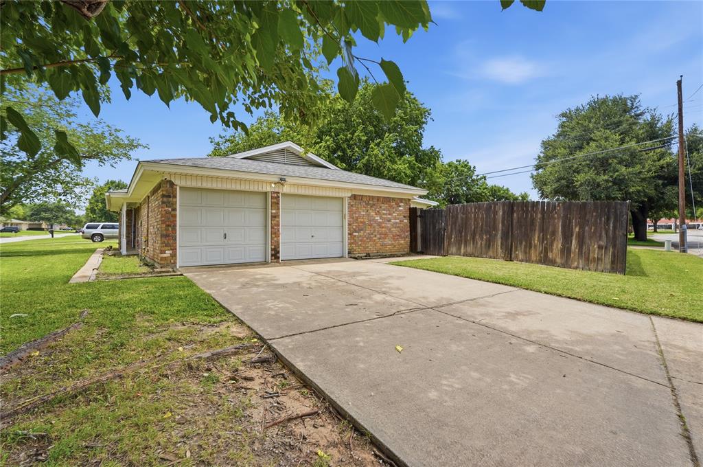 837 Springdale Road Bedford, TX 76021 - Photo 27 of 28 Brick exterior with a two-car garage