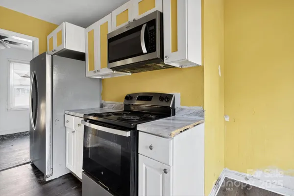a kitchen with stainless steel appliances wooden cabinets and a stove top oven