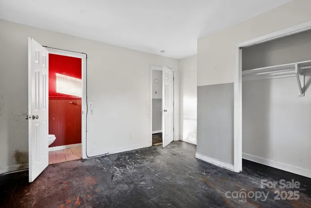a view of a bedroom with closet area