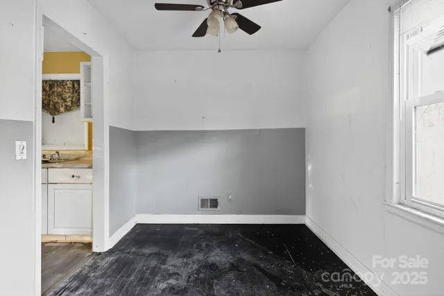 wooden floor in an empty room with a window