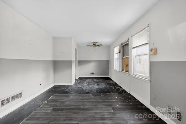 a view of a room with wooden floor