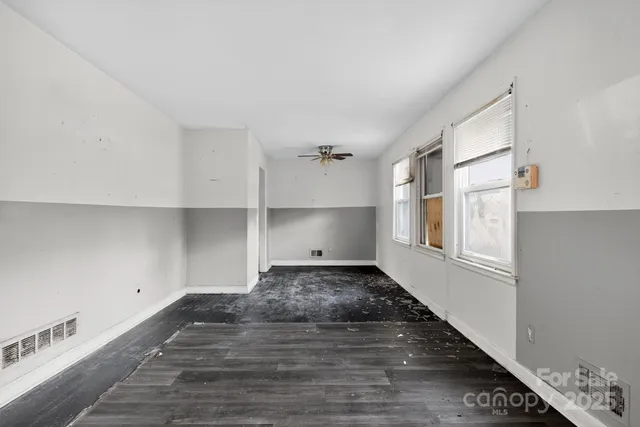 a view of a room with wooden floor