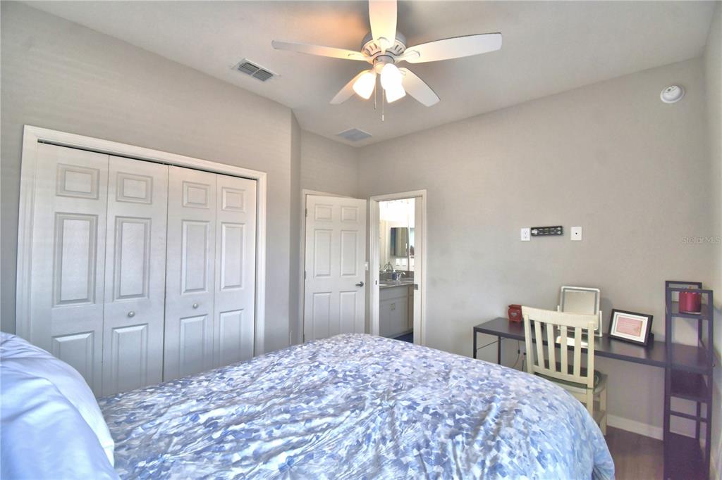 4340 Reding Way Lakeland, FL 33813 - Photo 35 of 63 a bedroom with a bed a table and chair