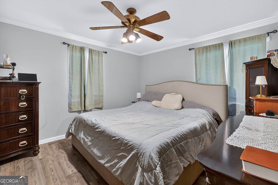 33 Warren Avenue Waverly, GA 31565 - Photo 9 of 63 a bedroom with a bed and a chandelier