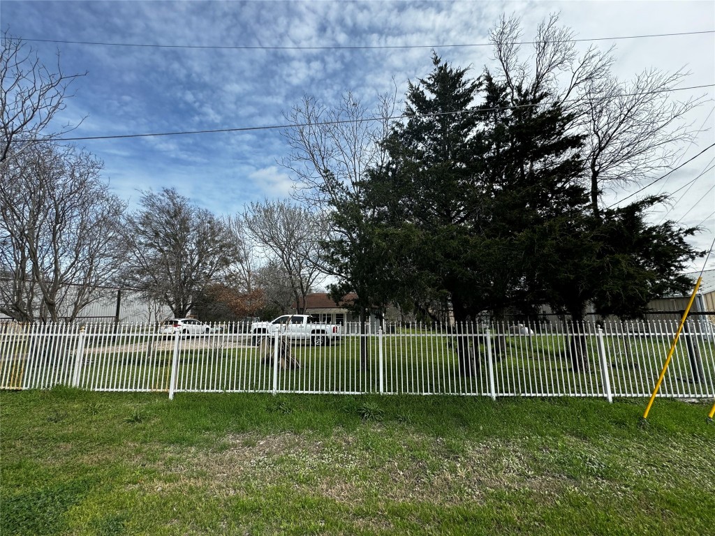 a view of a yard with a fence