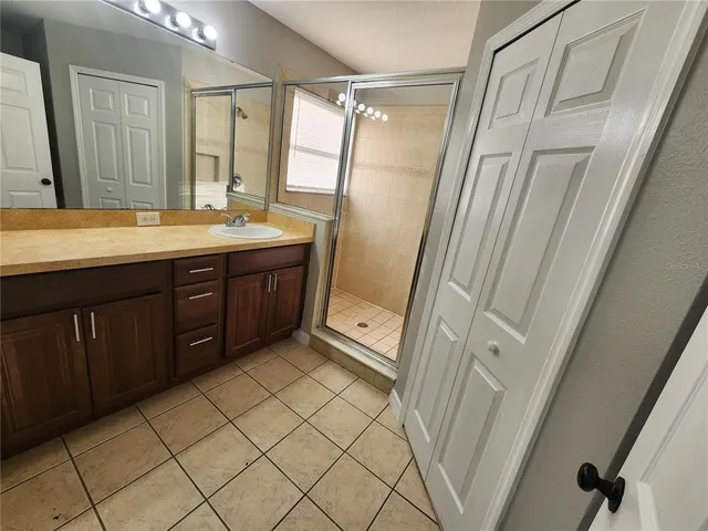 a bathroom with a double vanity sink and mirror
