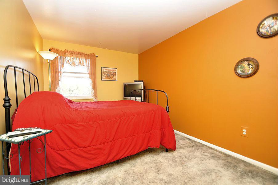4813 Vicky Road Baltimore, MD 21236 - Photo 17 of 22 a bedroom with a bed and a closet with mirror