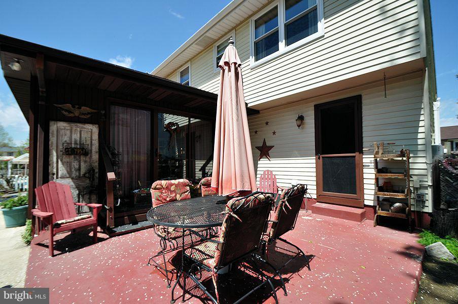 4813 Vicky Road Baltimore, MD 21236 - Photo 21 of 22 a backyard of a house with yard fire pit and chairs