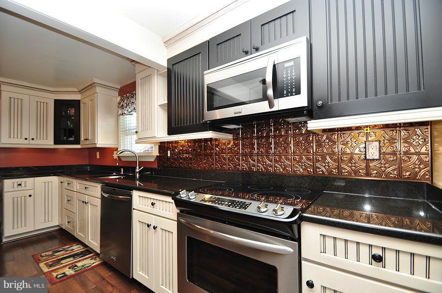 4813 Vicky Road Baltimore, MD 21236 - Photo 9 of 22 a kitchen with a stove and a microwave