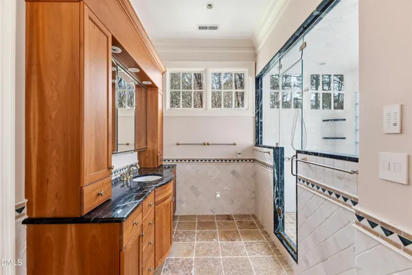 an empty room with windows and ceiling fan