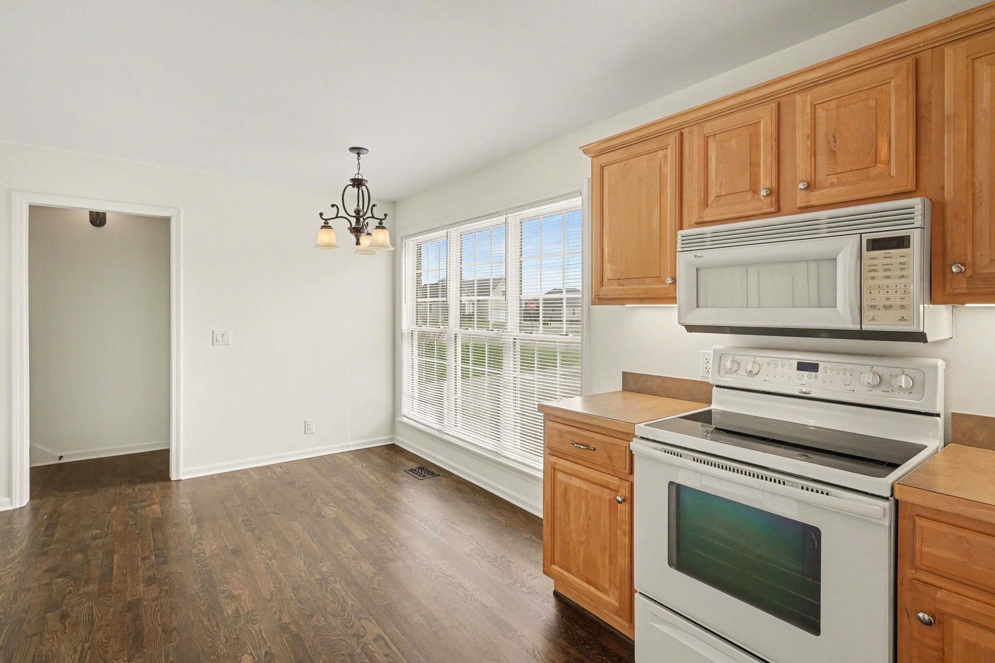 161 Fieldstone Lane Springfield, TN 37172 - Photo 9 of 26 a kitchen with granite countertop wooden cabinets stainless steel appliances and a wooden floor
