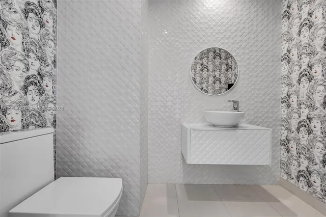 a white toilet sitting next to a shower