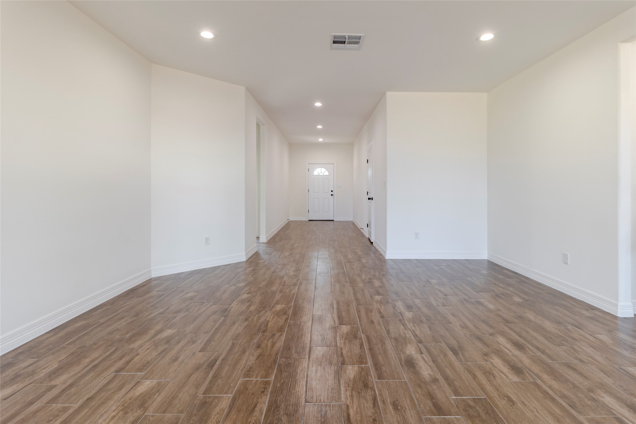 309 Myrtle Road Smithville, TX 78957 - Photo 5 of 17 Wide-plank, wood-look tile runs throughout the entire home, no carpet and no mixture of flooring from room to room.