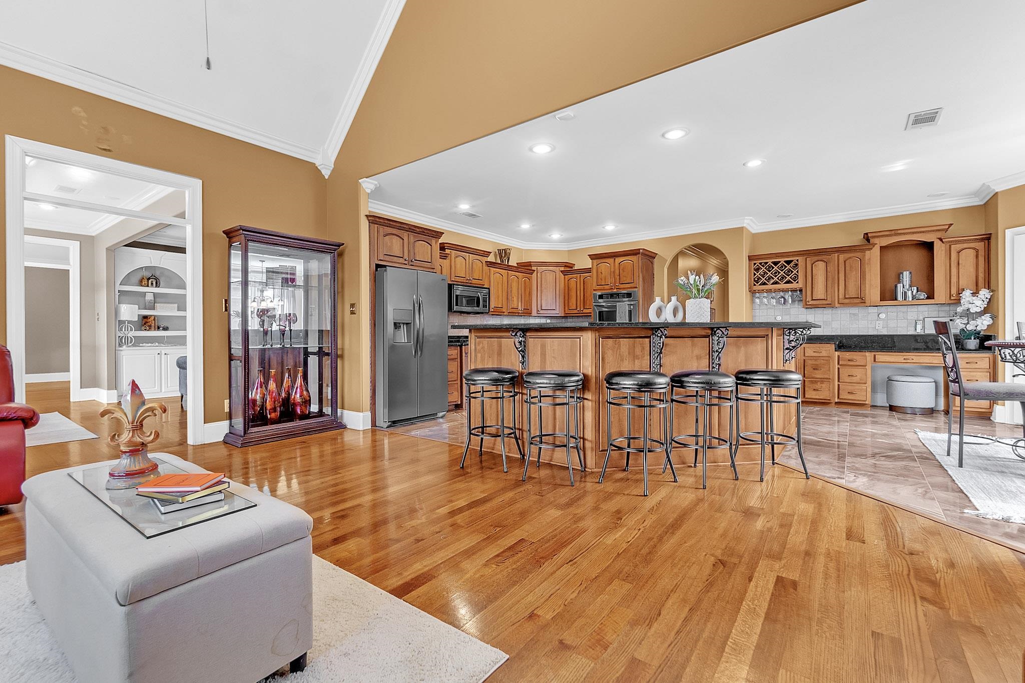 649 Ridge Springs Road Collierville, TN 38017 - Photo 16 of 38 Open-concept living space featuring wood-finish flooring, a vaulted ceiling, and recessed lighting