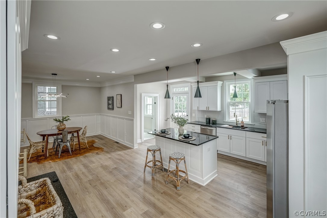 811 Overbrook Road Richmond, VA 23222 - Photo 19 of 50 Kitchen with white cabinetry, light hardwood / woo