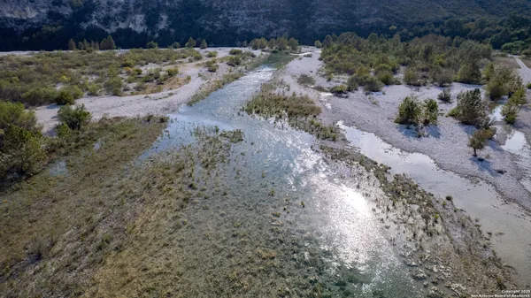 a view of a lake with beach and mountain view