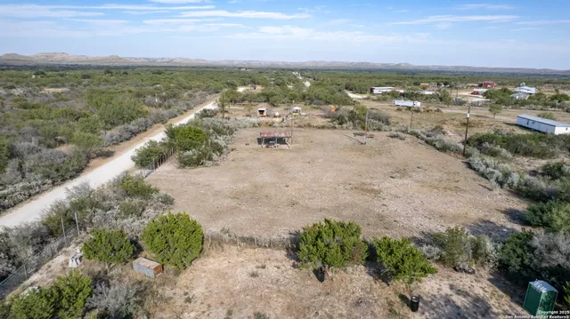 a view of a chair and table in the backyard