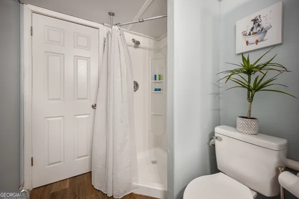a white toilet sitting next to a bathroom