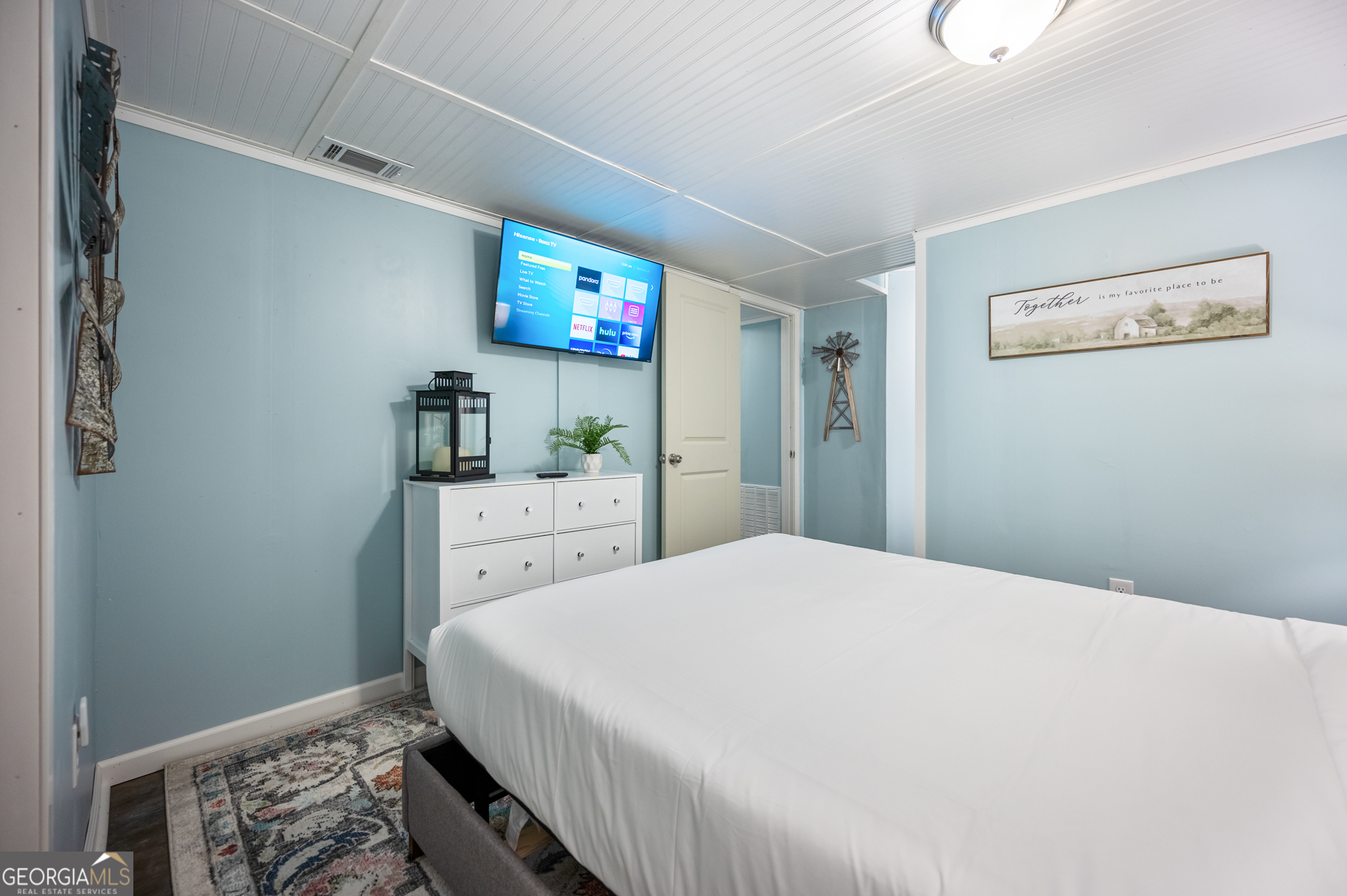 4297 Earney Road Woodstock, GA 30188 - Photo 13 of 35 a bedroom with a bed and a flat screen tv