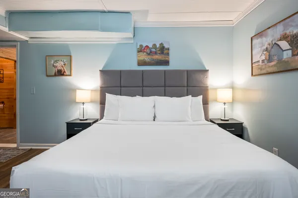 a bedroom with a bed and lamp