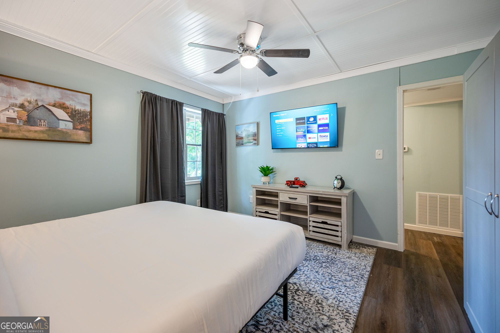 4297 Earney Road Woodstock, GA 30188 - Photo 17 of 35 a bedroom with a bed and a flat screen tv