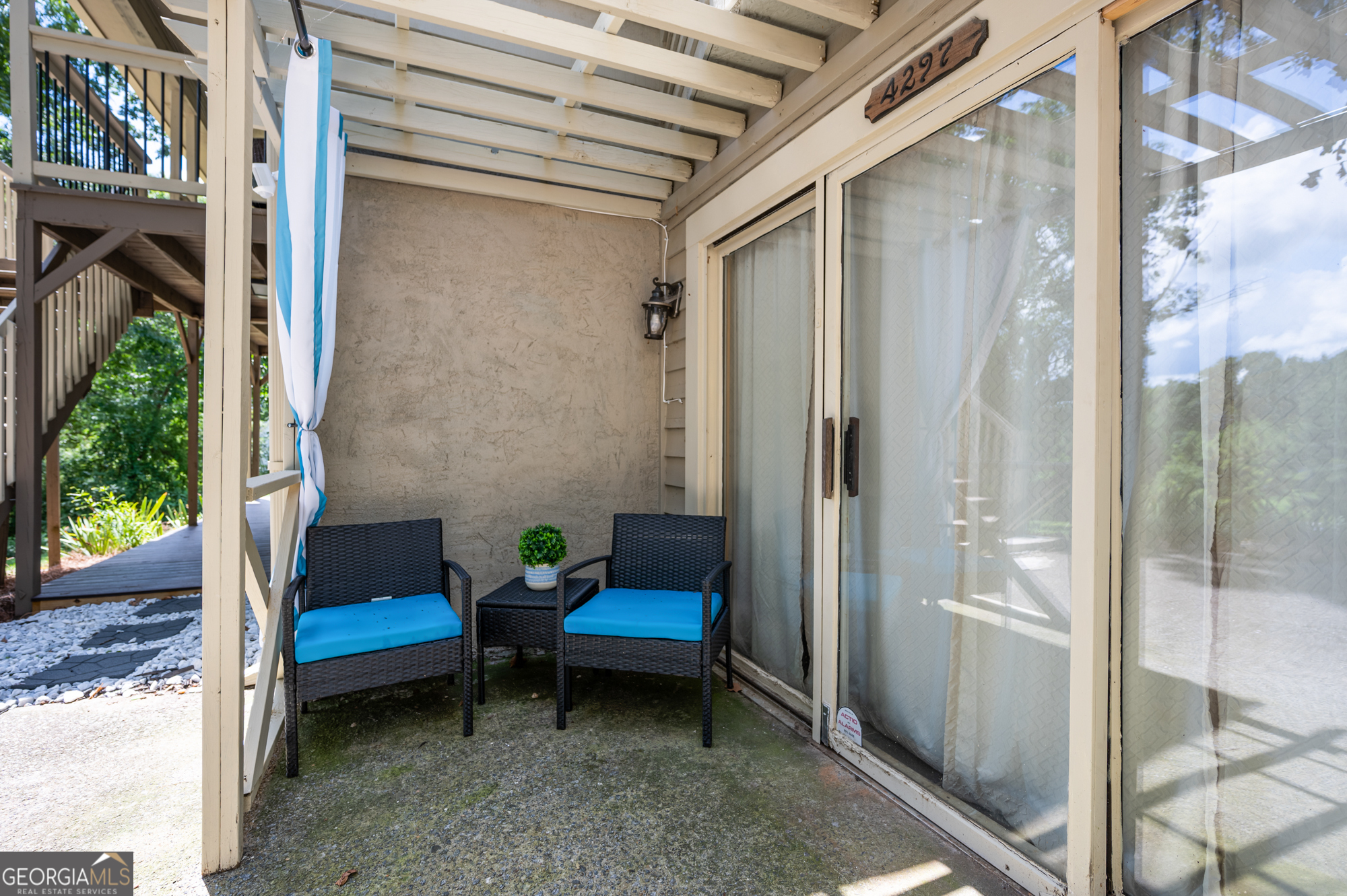 4297 Earney Road Woodstock, GA 30188 - Photo 25 of 35 a view of a balcony with chairs and a table