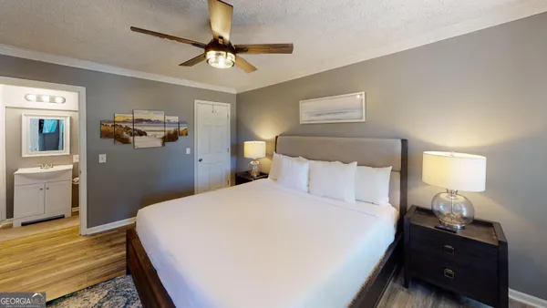 a bedroom with a bed and wooden floor