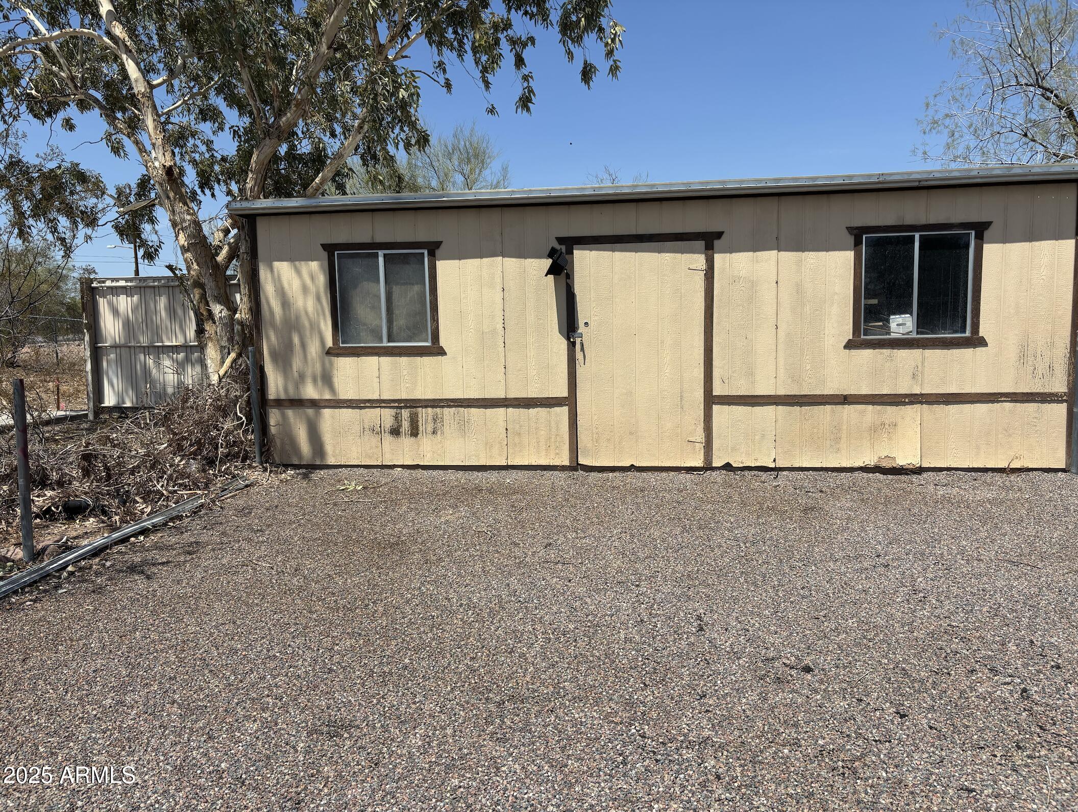 685 South Tomahawk Road Apache Junction, AZ 85119 - Photo 11 of 15 a house with trees in the background