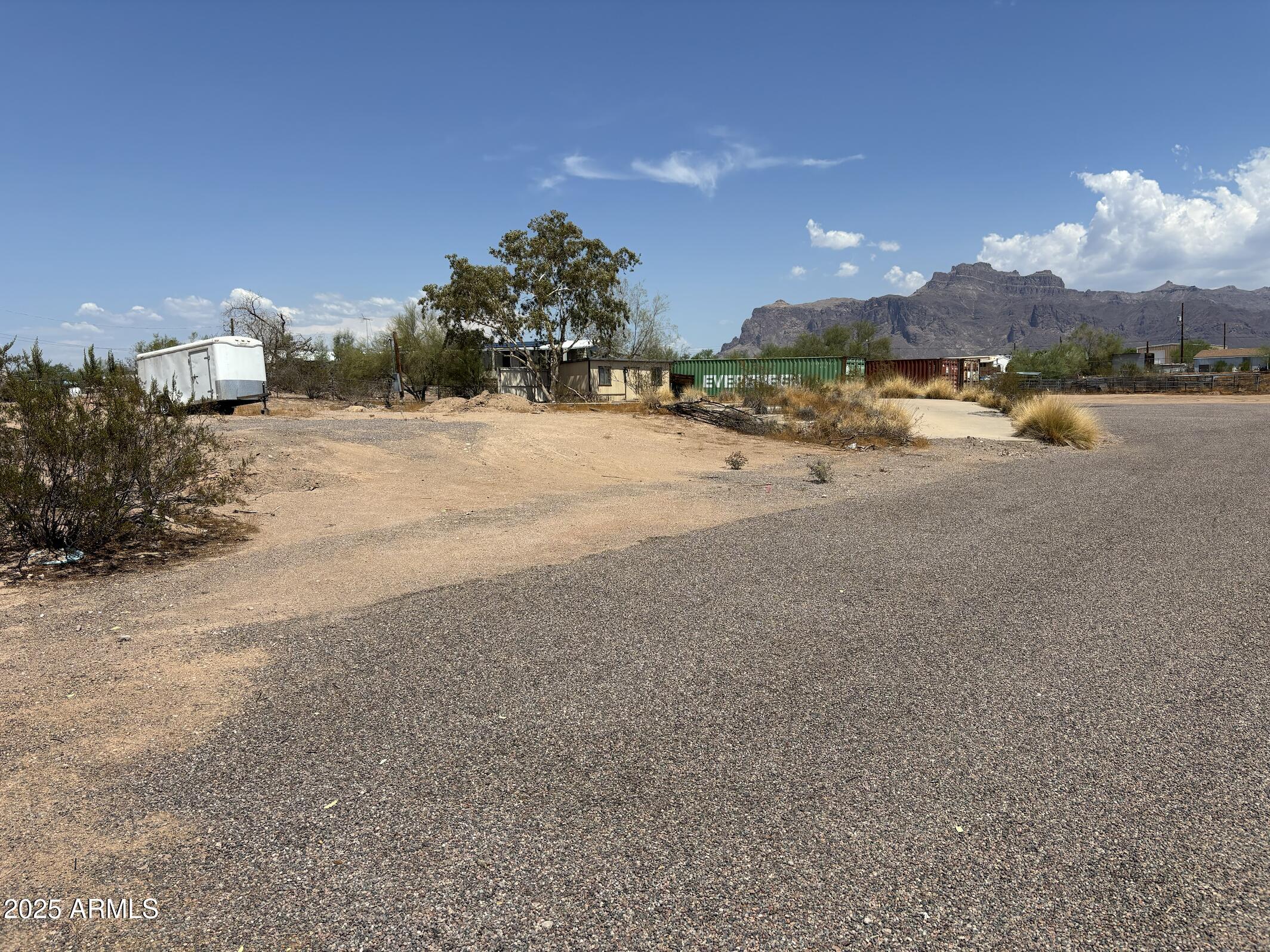 685 South Tomahawk Road Apache Junction, AZ 85119 - Photo 4 of 15 a view of a house with a yard and a car park in the background