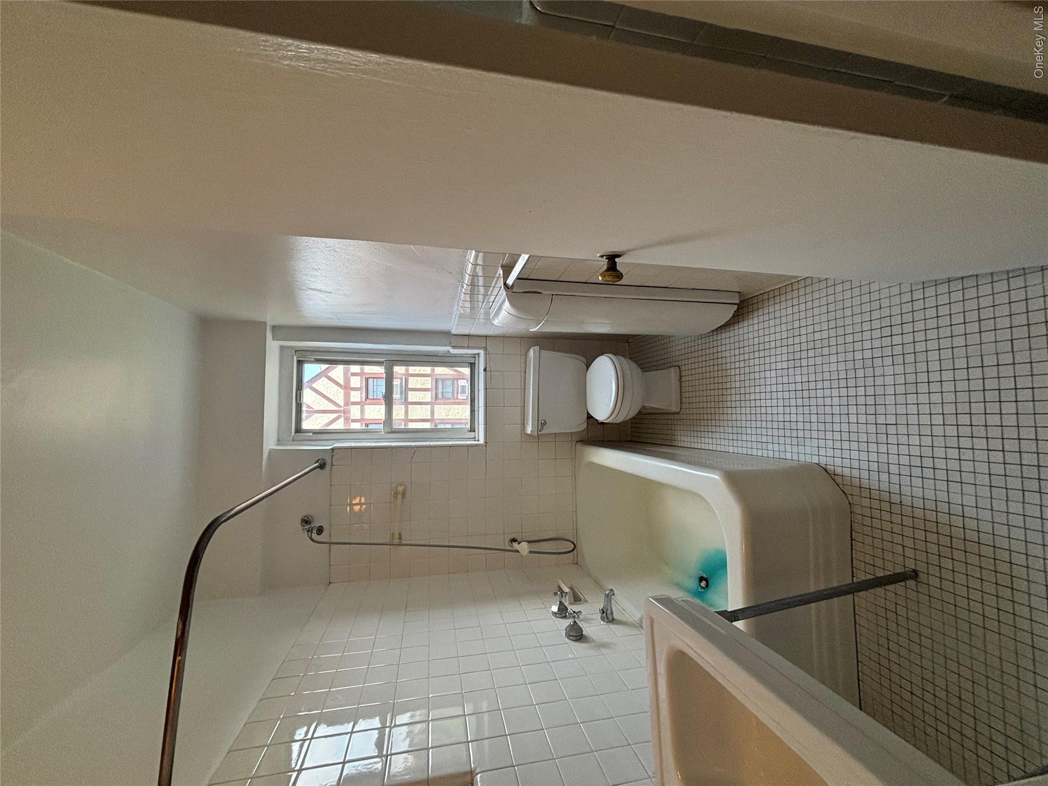 235 Garth Road, Unit A6F Scarsdale, NY 10583 - Photo 7 of 9 White tile flooring and wall tiling