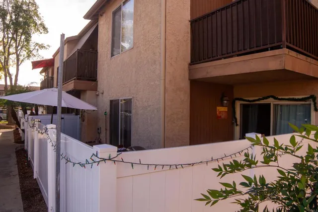 a view of a house with wooden fence