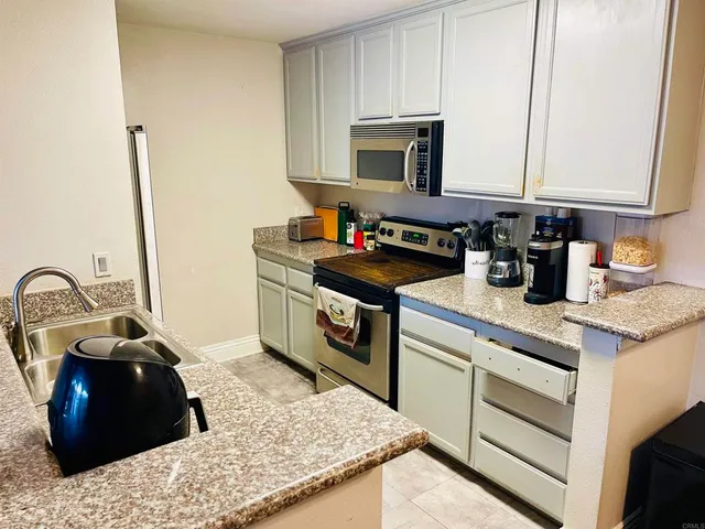 a kitchen with a stove and a sink